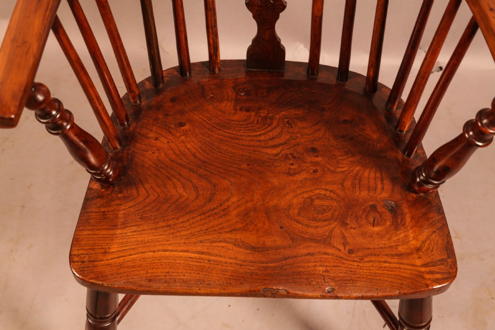 A low-back yew wood Windsor armchair featuring turned legs, a shaped seat, a pierced central back splat, and a curved crinoline stretcher. View X