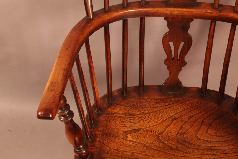 An antique yew wood Windsor armchair with a hoop back, pierced splat, curved armbow, turned legs, and a crinoline stretcher. View VIII