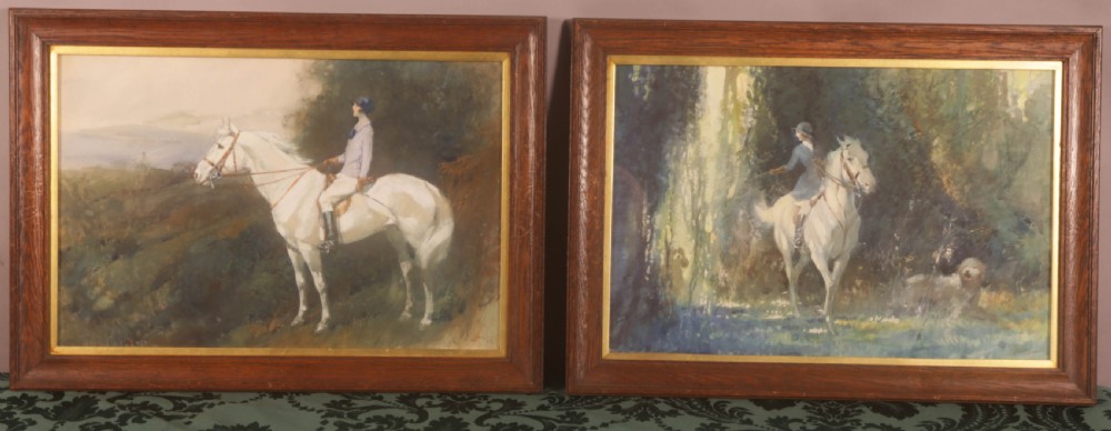 A pair of framed watercolour paintings depicting equestrian subjects within dark wooden frames with gilt inner liners.