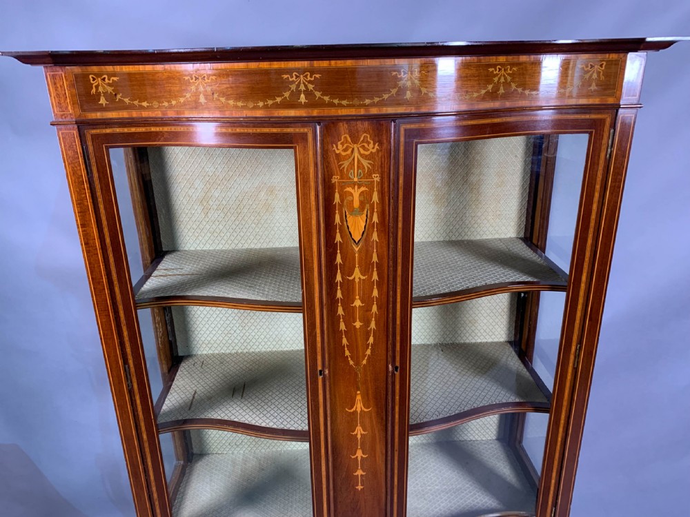 A Late Victorian Mahogany with inlay serpentine shape display cabinet View II