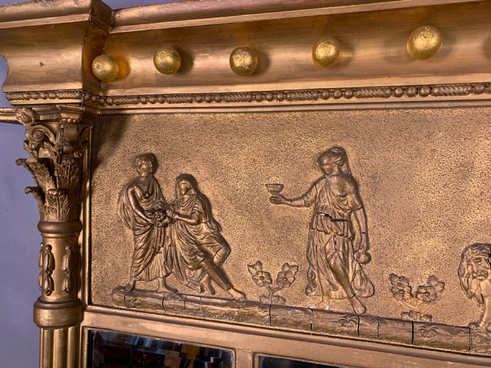 A rectangular nineteenth century gilded overmantel mirror featuring a classical relief frieze and fluted side columns. View III