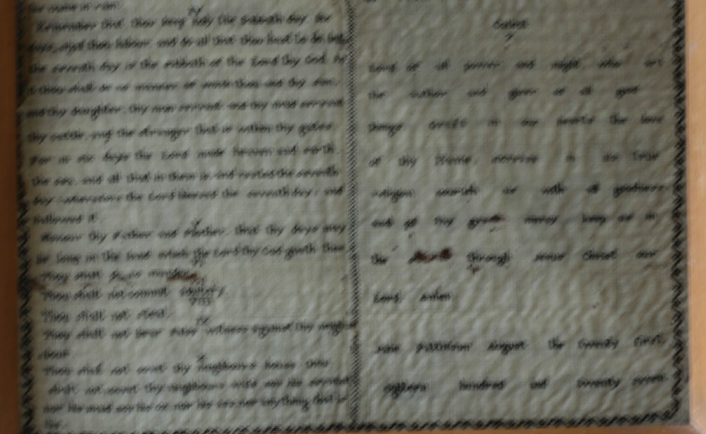 An 1827 Georgian embroidered needlework sampler featuring the Ten Commandments, the Lords Prayer, and an alphabet border set in a wooden frame. View VIII