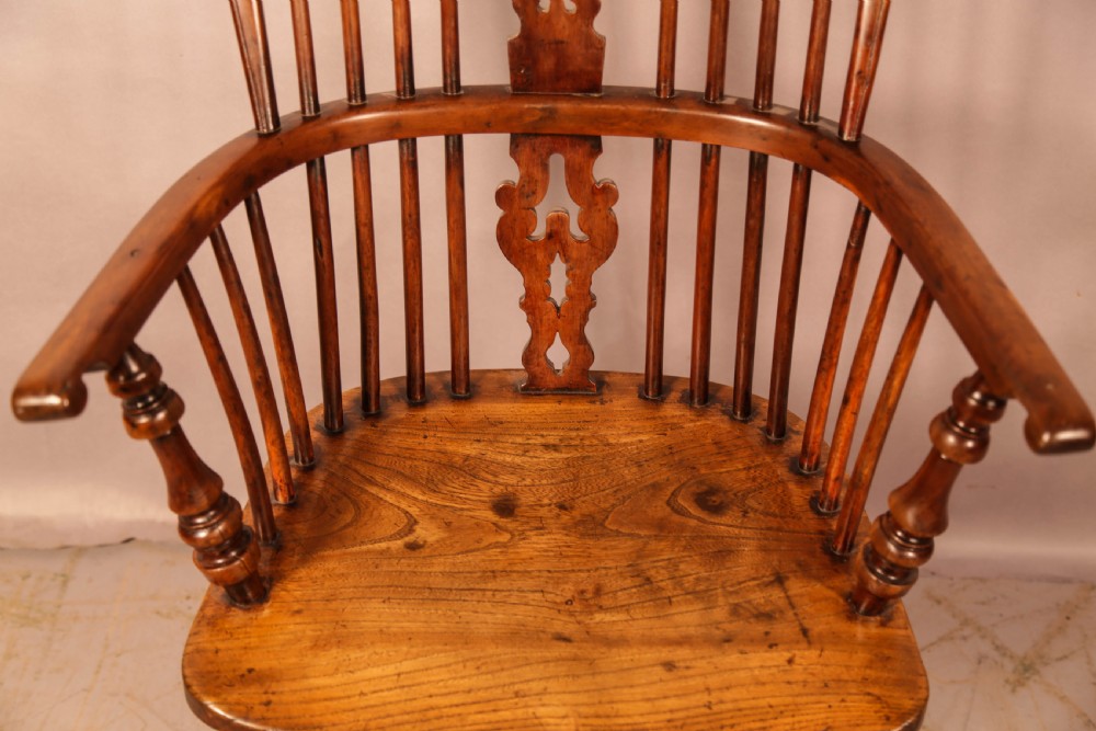 An antique yew wood Windsor armchair featuring a pierced back splat, spindle backrest, turned legs, and a crinoline stretcher. View VI