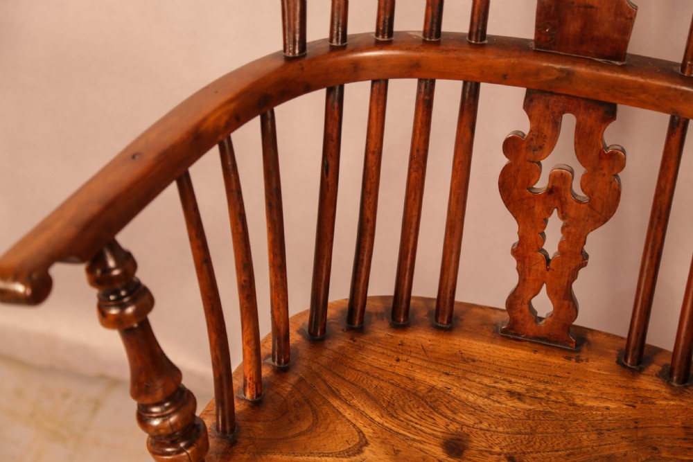 An antique yew wood Windsor armchair featuring a pierced back splat, spindle backrest, turned legs, and a crinoline stretcher. View VII