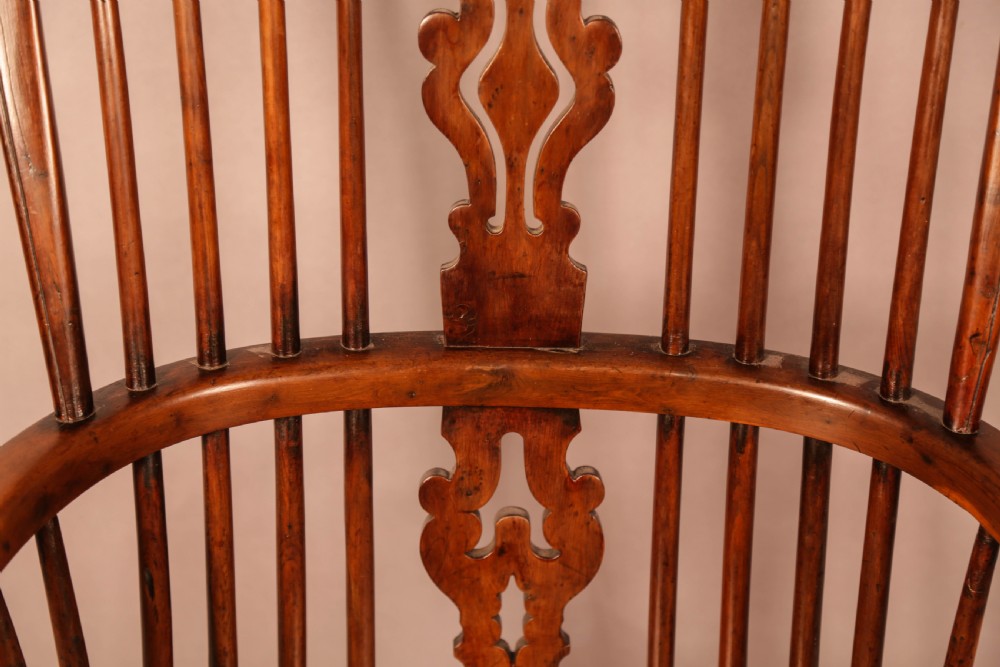 An antique yew wood Windsor armchair featuring a pierced back splat, spindle backrest, turned legs, and a crinoline stretcher. View VIII