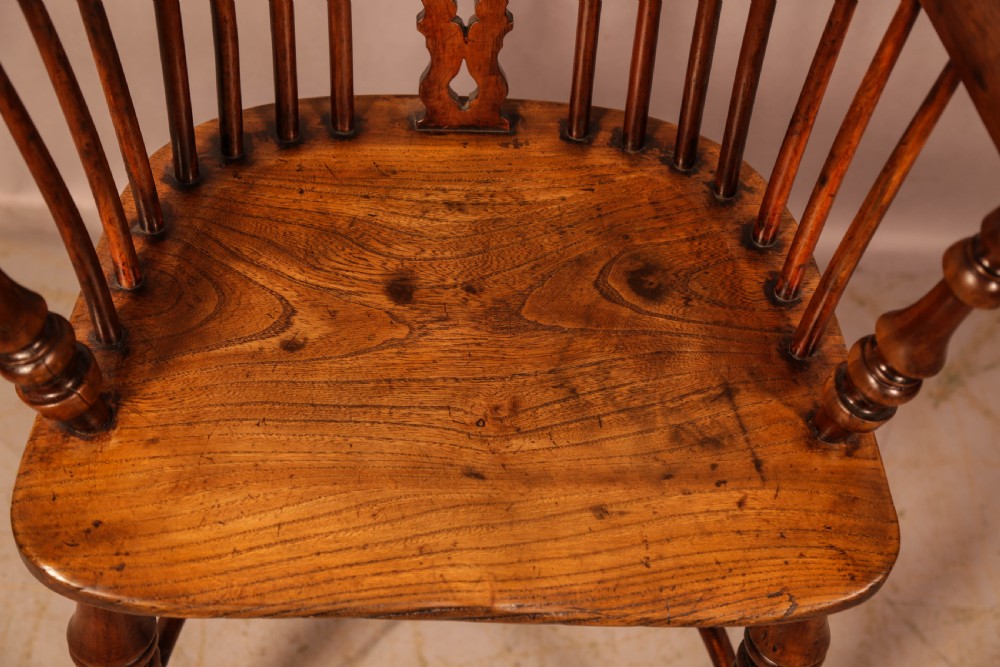 An antique yew wood Windsor armchair featuring a pierced back splat, spindle backrest, turned legs, and a crinoline stretcher. View XI