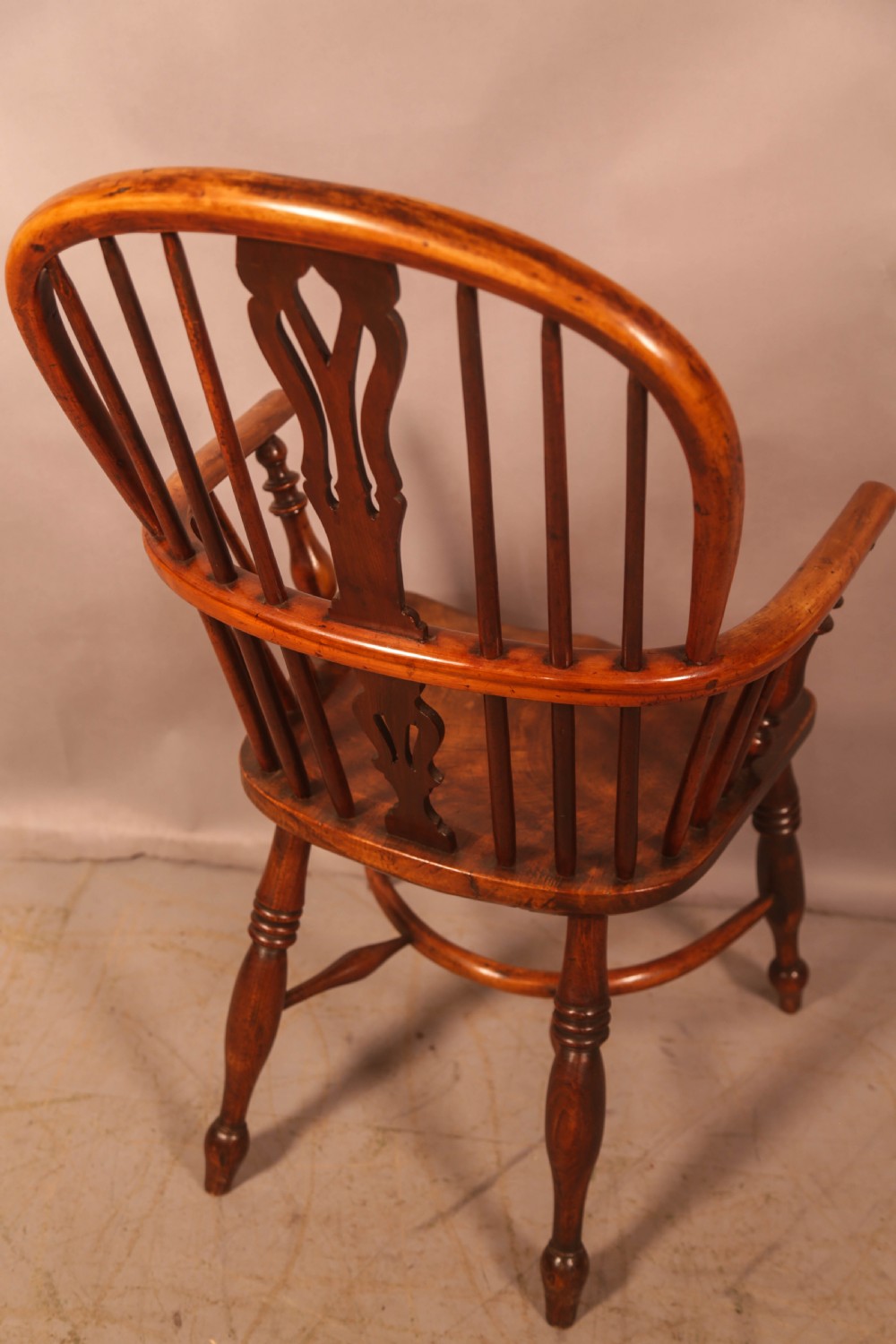 A 19th-century high back Windsor armchair made from yew wood with a shaped elm seat, turned legs, and a pierced decorative splat. View IV