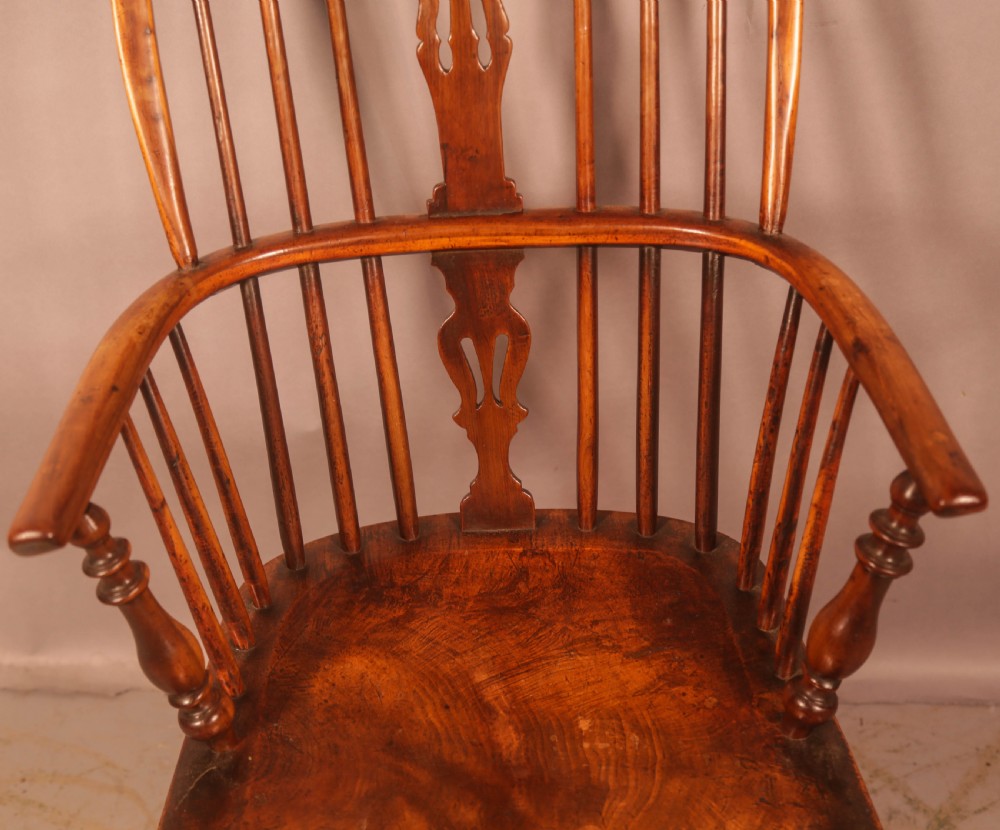 A 19th-century high back Windsor armchair made from yew wood with a shaped elm seat, turned legs, and a pierced decorative splat. View V