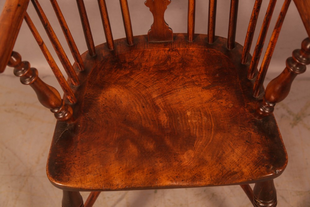 A 19th-century high back Windsor armchair made from yew wood with a shaped elm seat, turned legs, and a pierced decorative splat. View X