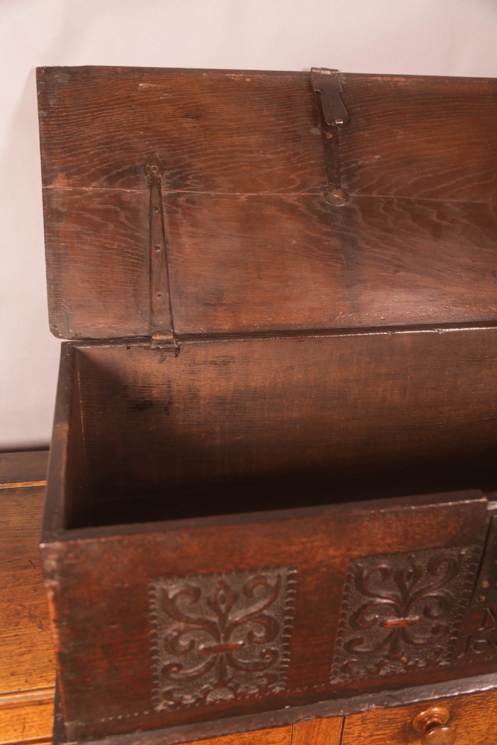 A 17th-century carved dark oak document box with an iron latch, carved initials MB, and date 1695 on the front panel. View VII