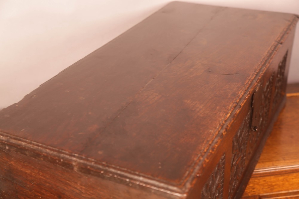 A 17th-century carved dark oak document box with an iron latch, carved initials MB, and date 1695 on the front panel. View IX