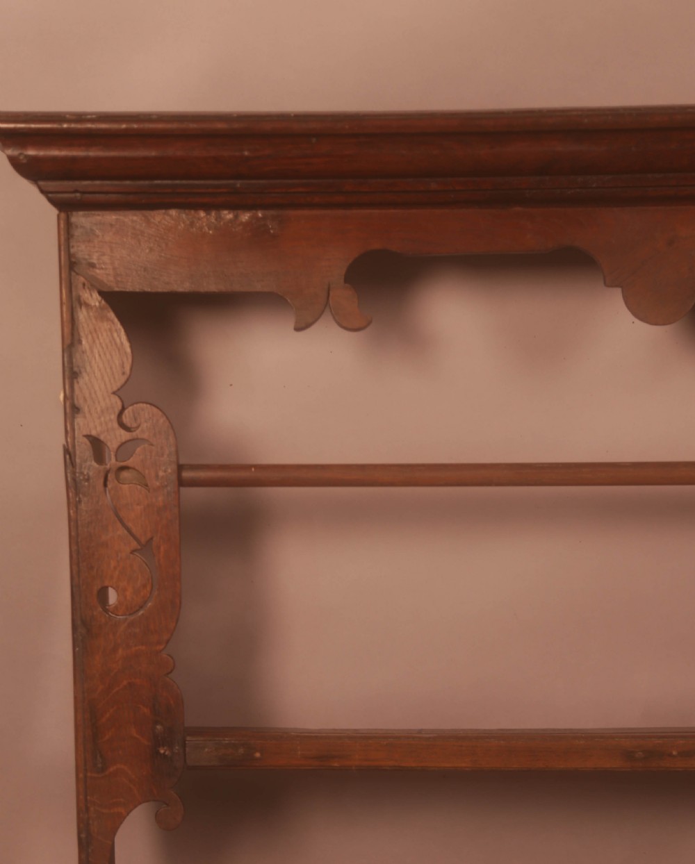 A Georgian dark oak wall-mounted plate rack featuring three horizontal shelves with retaining rails, a moulded top cornice, and decorative fretwork aprons. View III