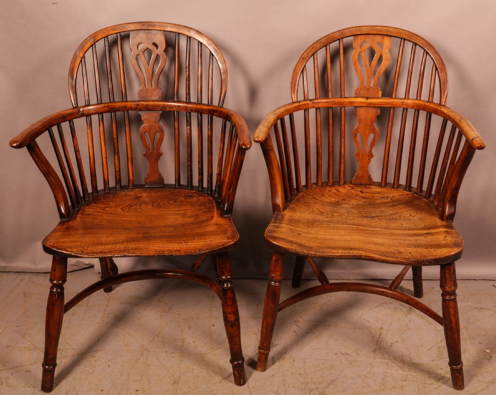 A set of four wooden Windsor armchairs featuring pierced splats, spindle backs, and sculpted seats. View VII