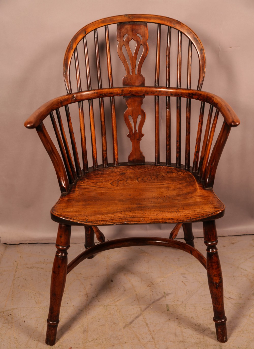 A set of four wooden Windsor armchairs featuring pierced splats, spindle backs, and sculpted seats. View VIII