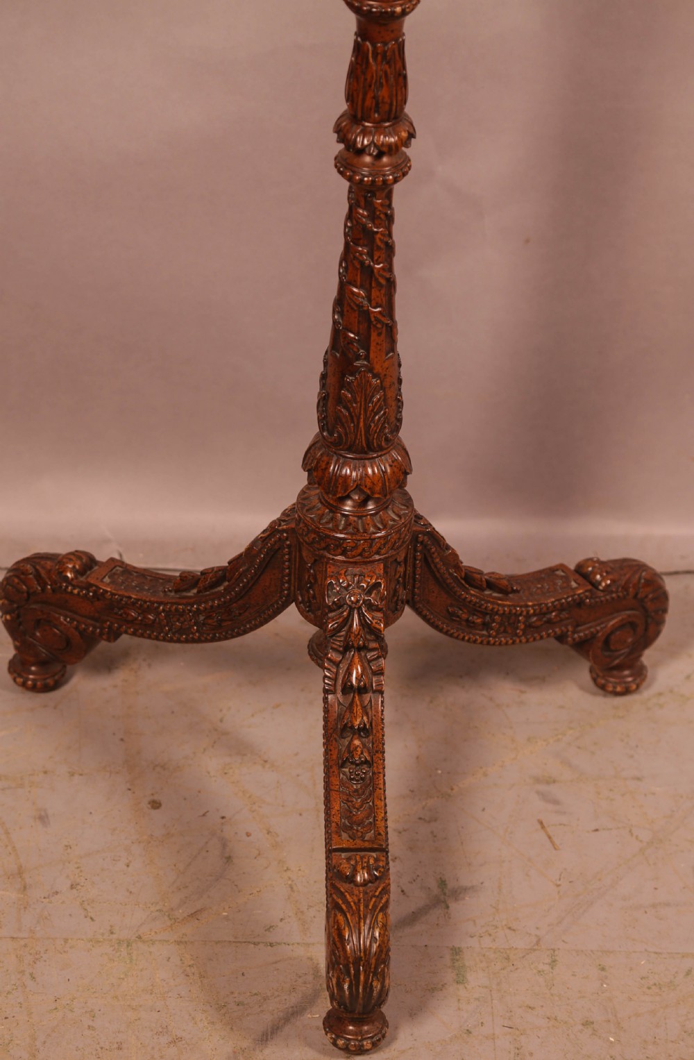 A nineteenth-century dark wood pole screen featuring an embroidered floral tapestry panel mounted on a brass rod with a heavily carved tripod base. View III