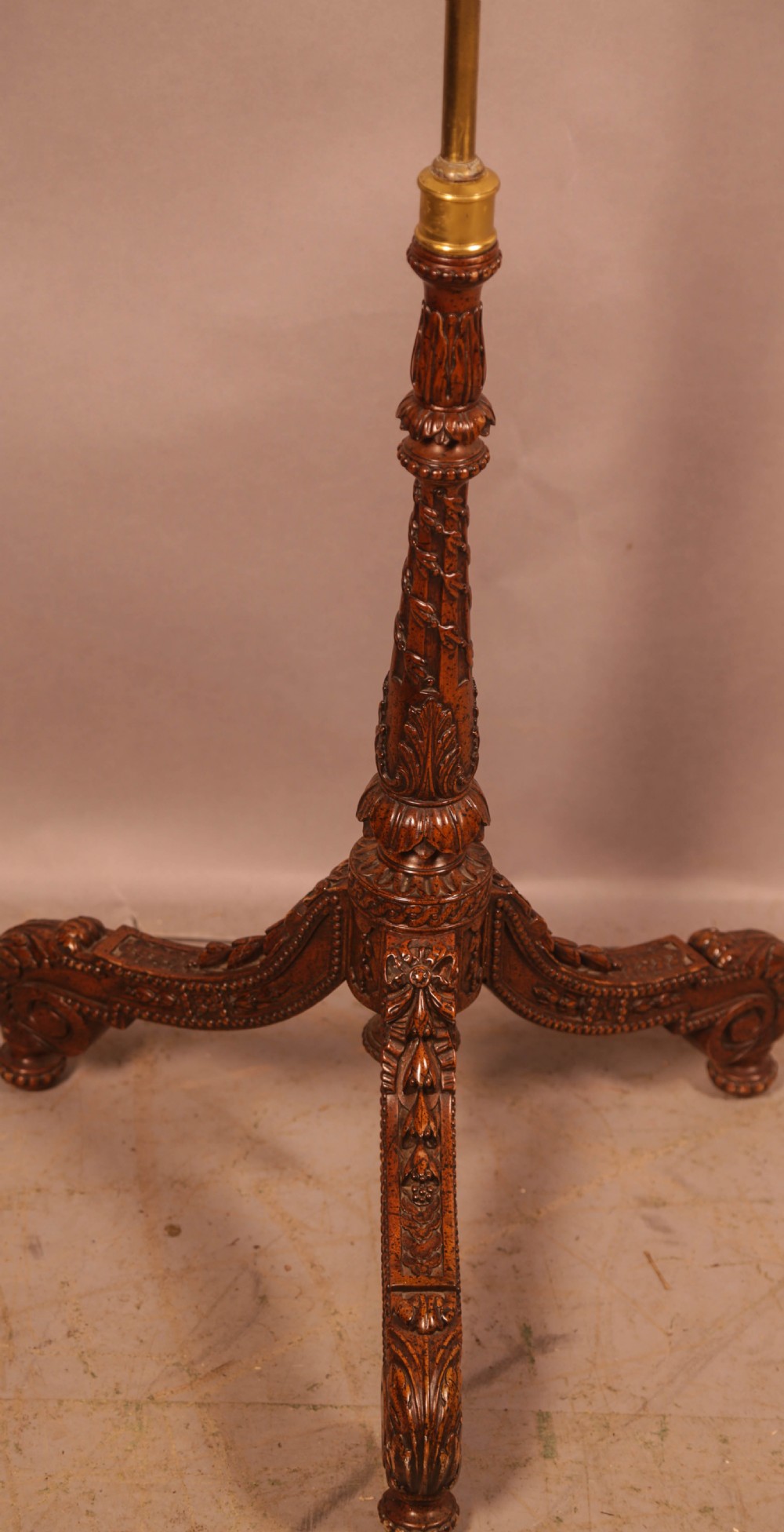 A nineteenth-century dark wood pole screen featuring an embroidered floral tapestry panel mounted on a brass rod with a heavily carved tripod base. View V