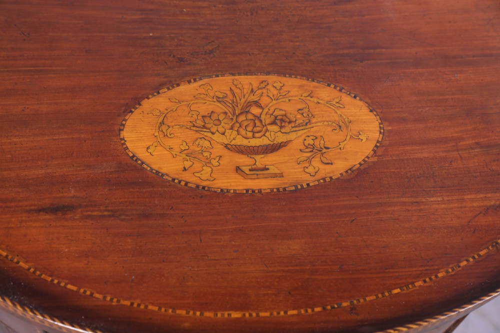An eighteenth-century mahogany demi-lune cabinet featuring intricate geometric inlay, tambour doors, and brass hardware. View VIII