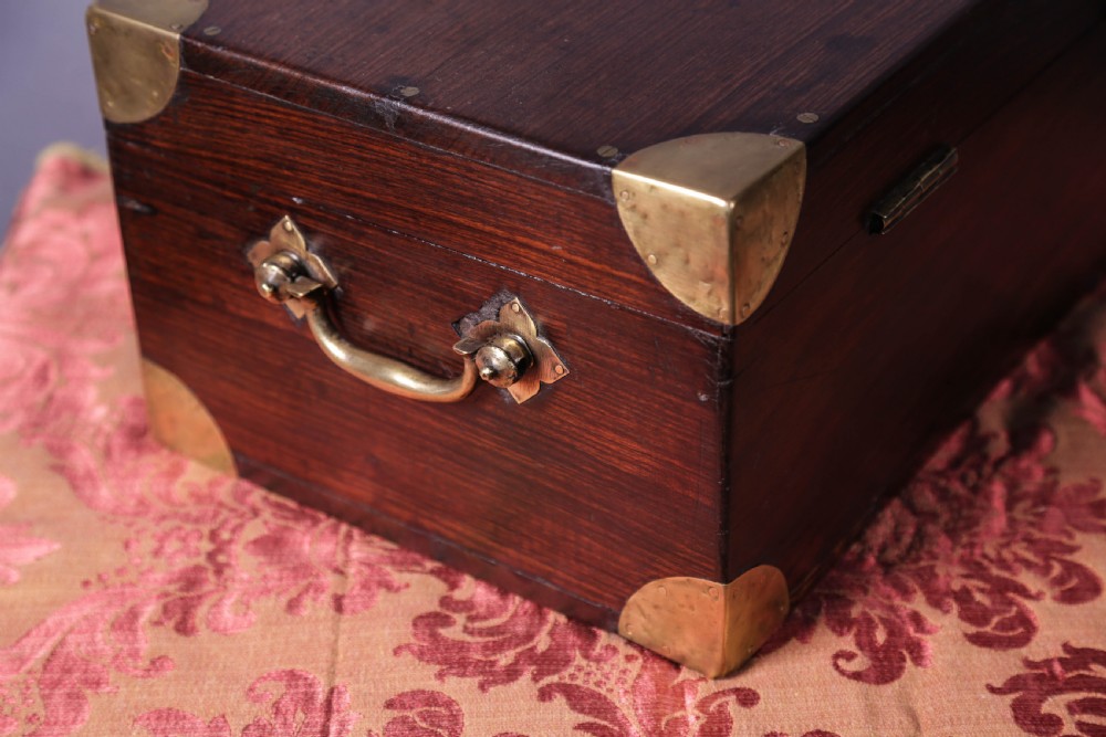 A rectangular rosewood campaign box featuring brass corner brackets, a central keyhole escutcheon, and side carry handles. View II