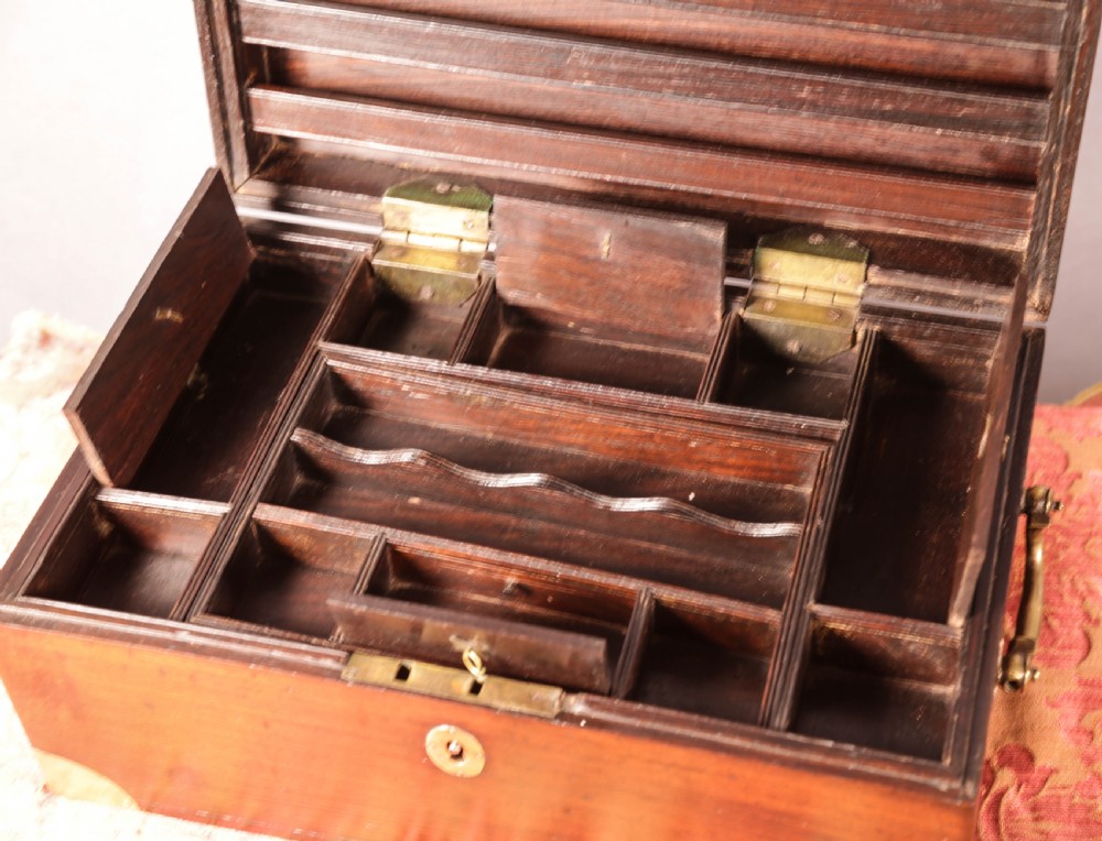 A rectangular rosewood campaign box featuring brass corner brackets, a central keyhole escutcheon, and side carry handles. View VII