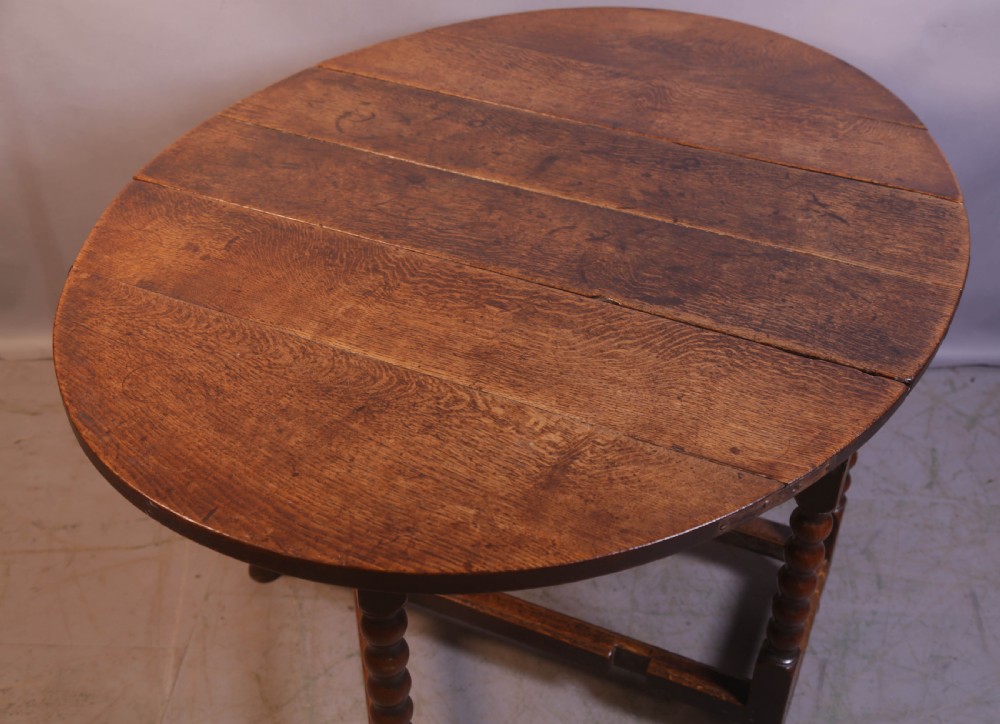 Seventeenth-century oak gateleg table featuring drop-leaf flaps, turned legs, and stretchers. View III