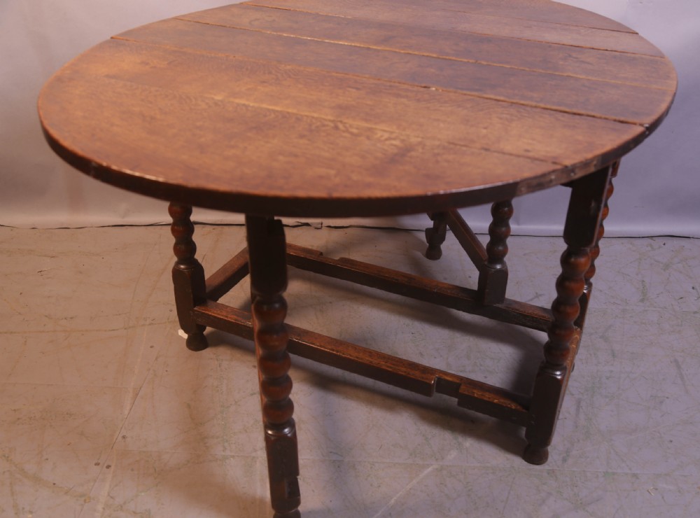 Seventeenth-century oak gateleg table featuring drop-leaf flaps, turned legs, and stretchers. View IV