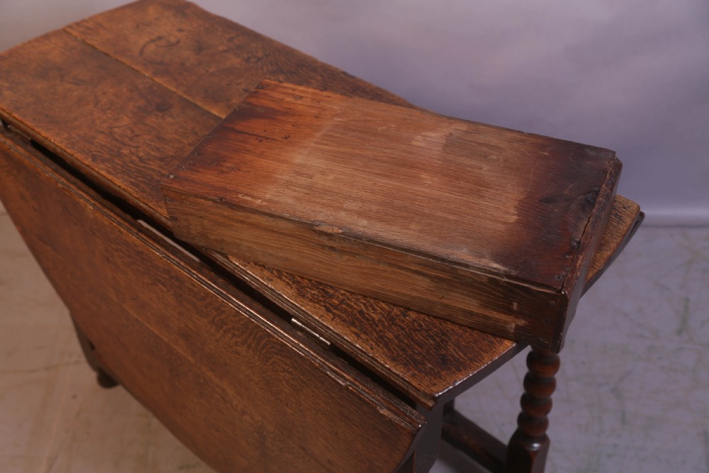 Seventeenth-century oak gateleg table featuring drop-leaf flaps, turned legs, and stretchers. View VII