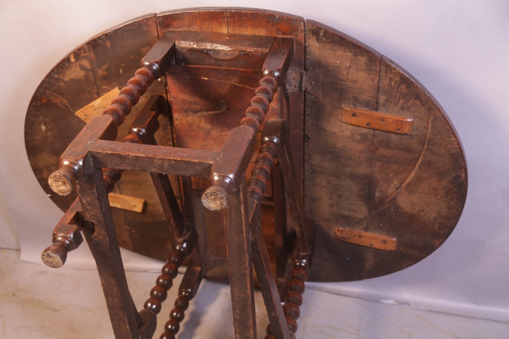 Seventeenth-century oak gateleg table featuring drop-leaf flaps, turned legs, and stretchers. View VIII