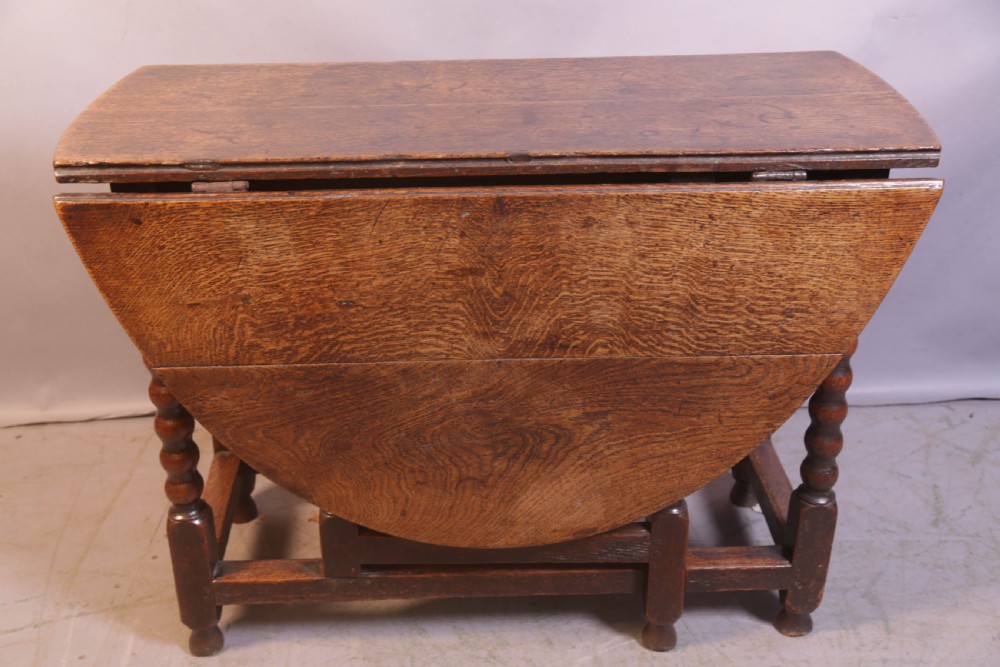 Seventeenth-century oak gateleg table featuring drop-leaf flaps, turned legs, and stretchers. View IX