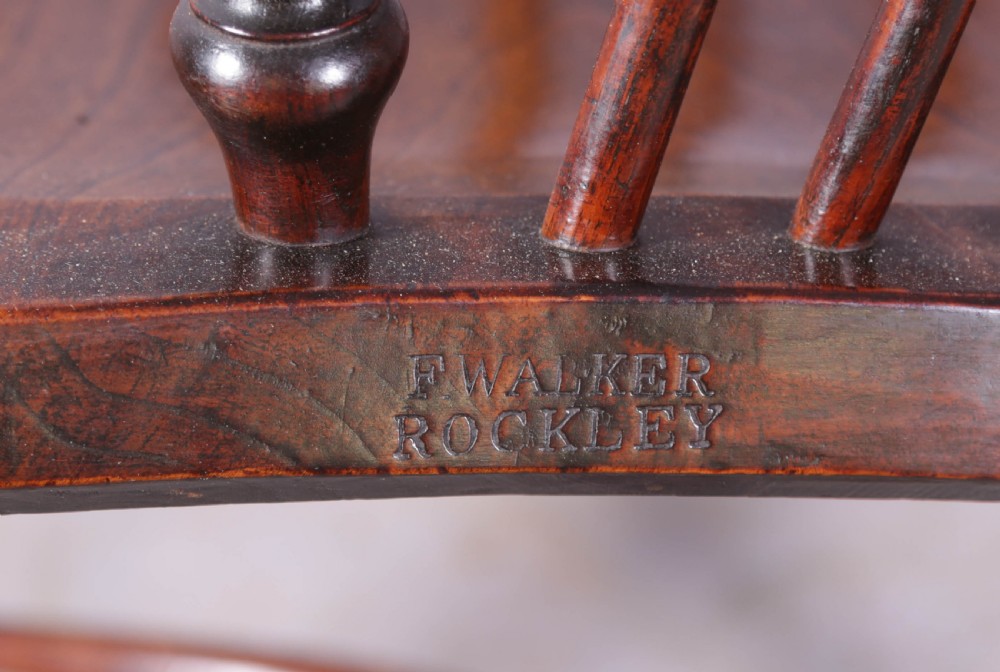 An antique ash and elm Windsor armchair featuring a steam-bent hoop back, pierced splat, turned legs, and a crinoline stretcher. View IX