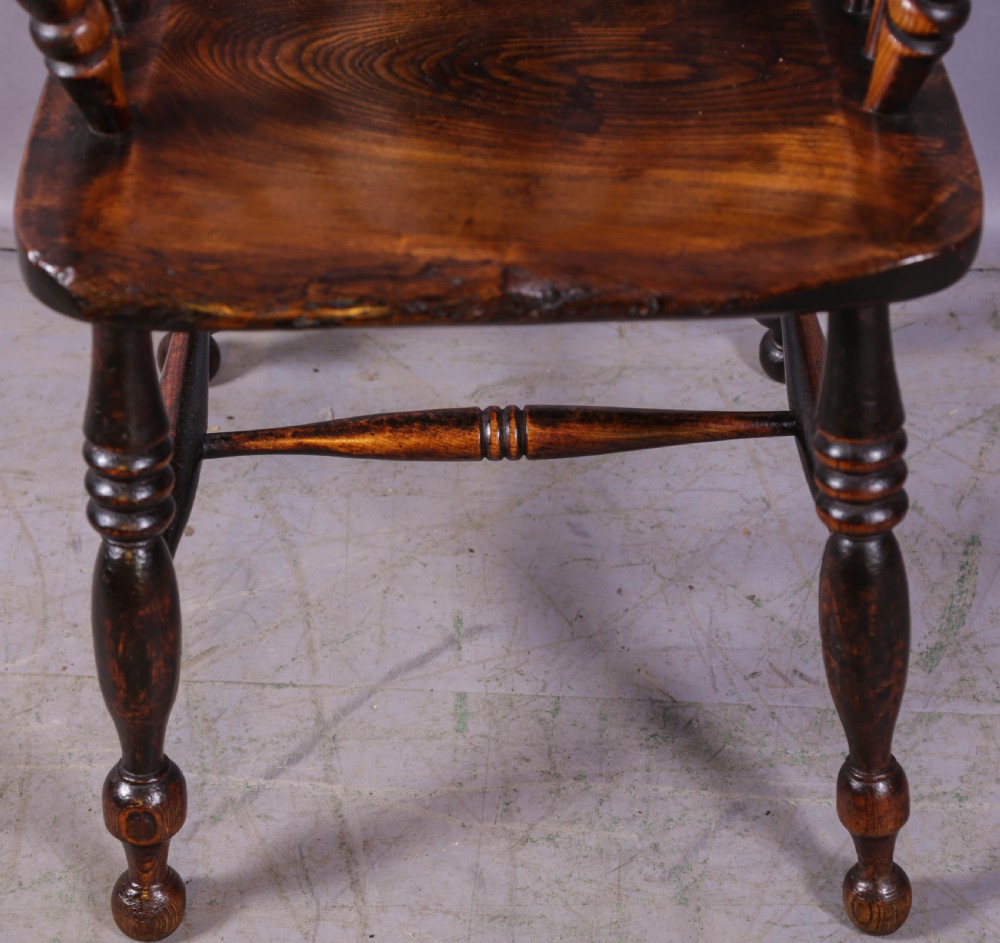 An antique high-back wooden Windsor armchair crafted from ash and elm with a pierced central splat, turned legs, and a shaped saddle seat. View VI