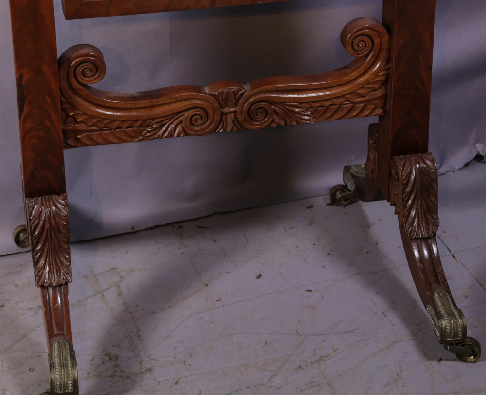 An American Empire mahogany cheval mirror with turned side columns, a pedimented top, brass mounts, and a carved scroll base with paw feet. View V