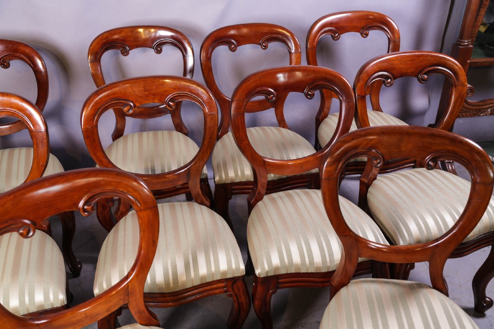 A set of ten Victorian mahogany dining chairs featuring characteristic balloon backrests and striped upholstery on cabriole legs. View IV