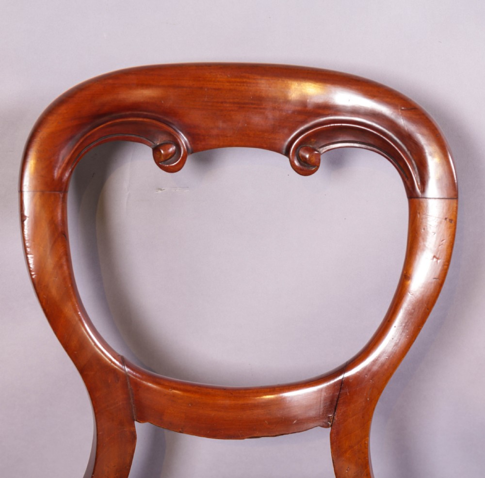 A set of ten Victorian mahogany dining chairs featuring characteristic balloon backrests and striped upholstery on cabriole legs. View XI