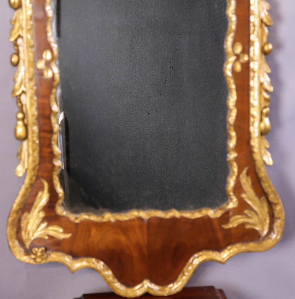 An 18th-century pier glass featuring a walnut veneer frame with elaborate giltwood carvings, scroll pediment, and a central carved eagle cresting. View VII