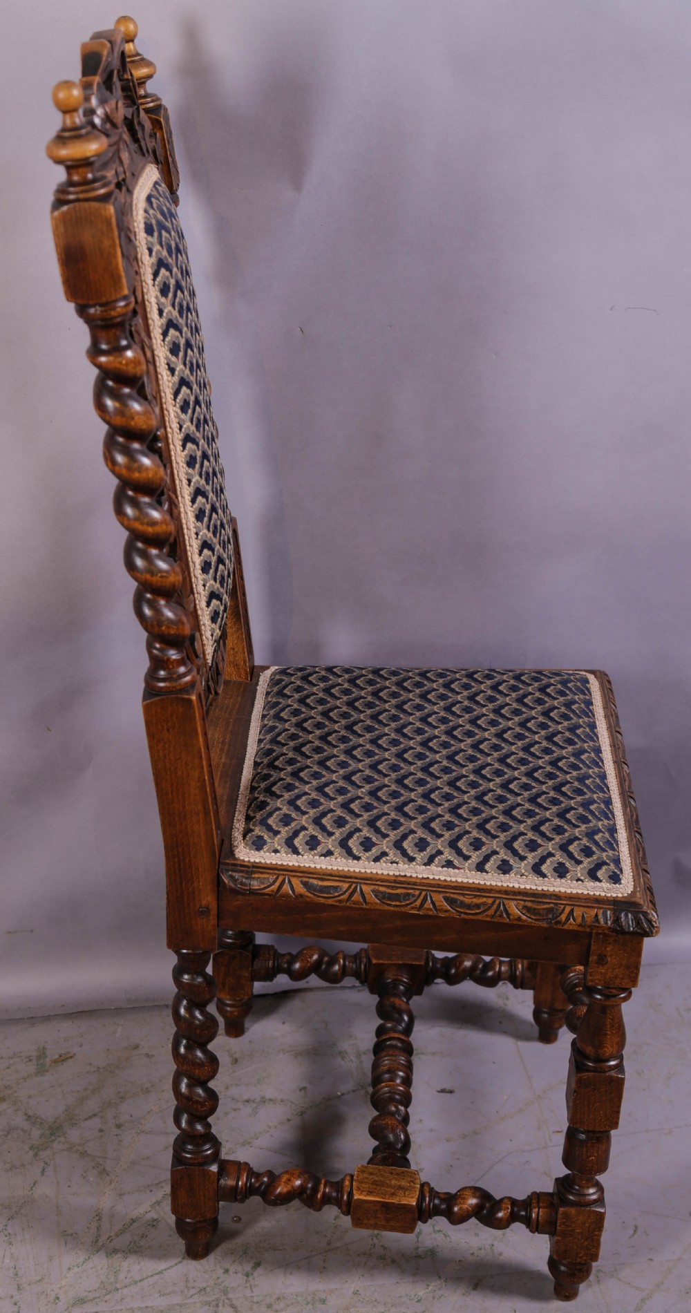 A set of six Victorian carved dining chairs featuring tall backs, barley twist uprights, and patterned upholstered seats. View VI