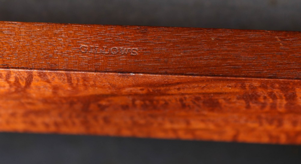 A 19th-century flame mahogany two-door estate cabinet with carved spandrel mouldings and turned bun feet. View XII