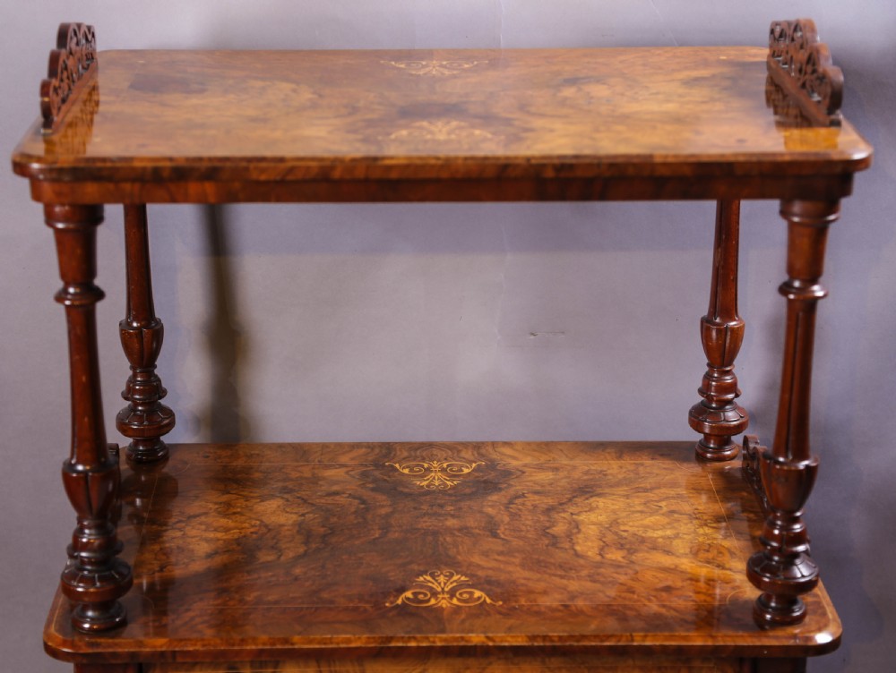 An antique Victorian burr walnut music cabinet featuring tiered shelves, marquetry inlay, turned columns, and a glazed door. View III