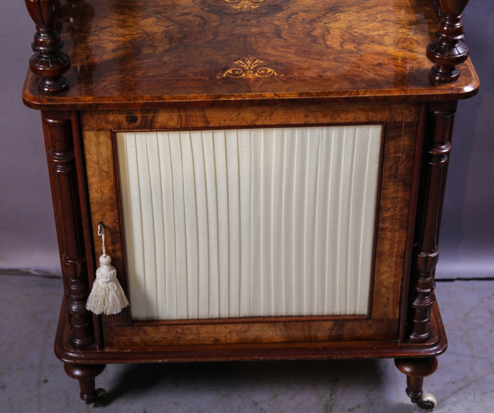 An antique Victorian burr walnut music cabinet featuring tiered shelves, marquetry inlay, turned columns, and a glazed door. View IV