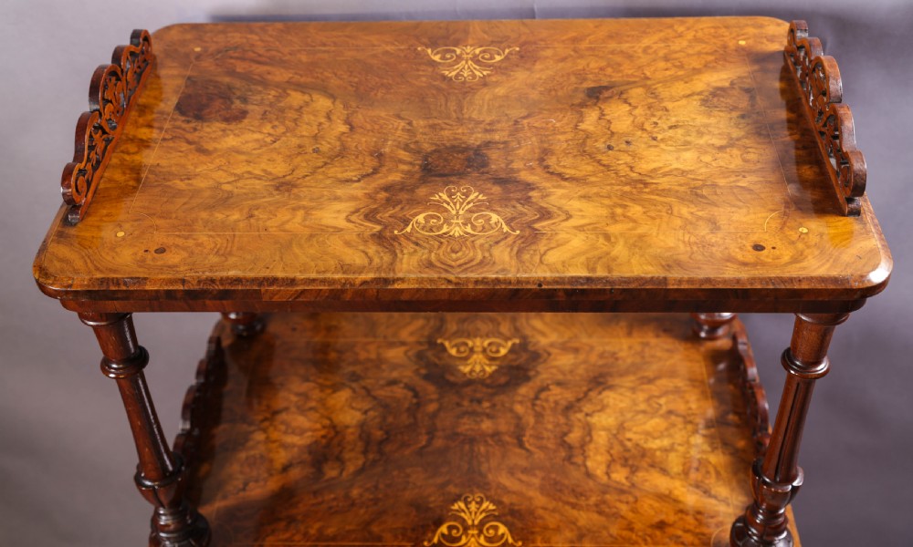 An antique Victorian burr walnut music cabinet featuring tiered shelves, marquetry inlay, turned columns, and a glazed door. View VI