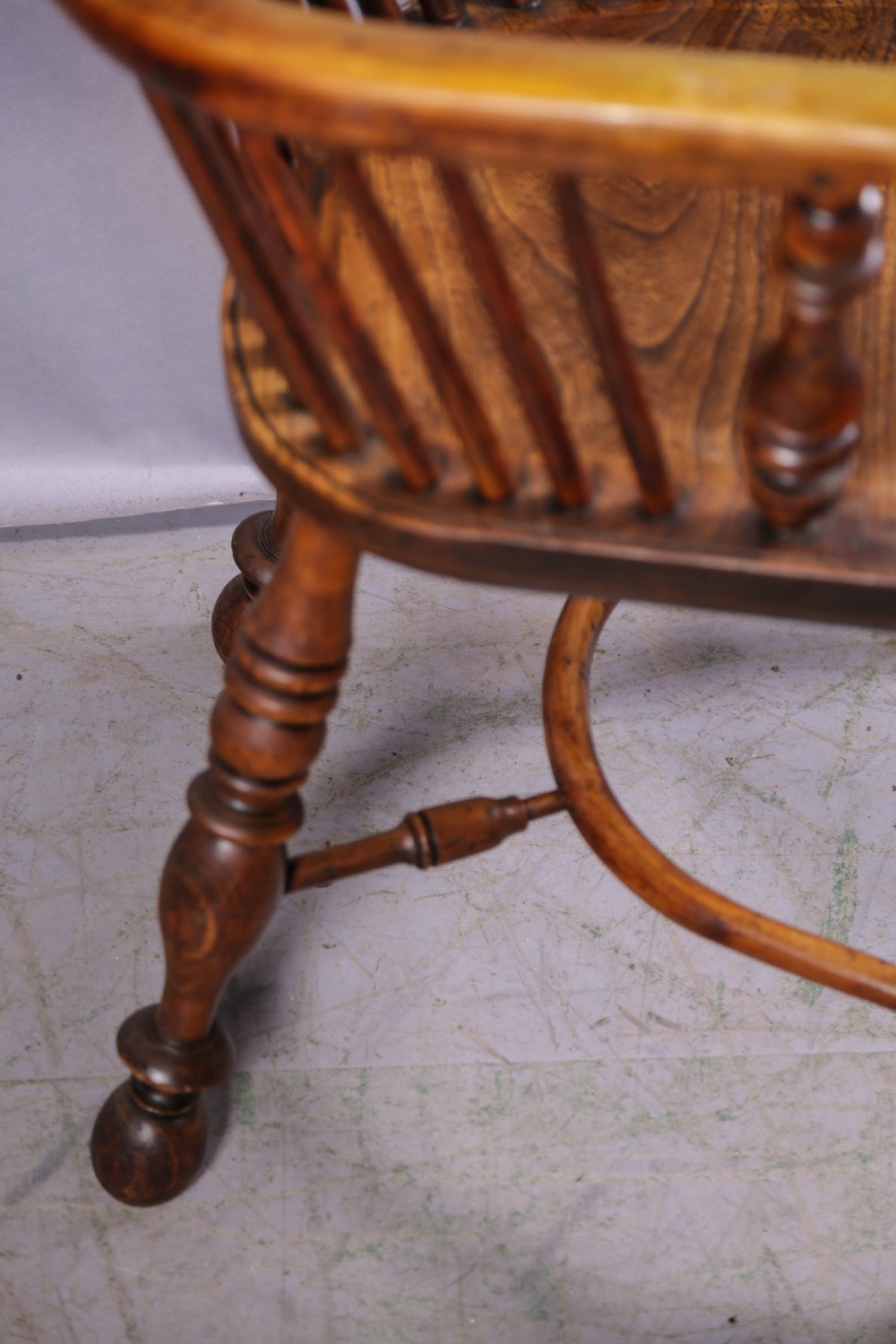 A 19th-century yew wood Windsor armchair featuring a bow back, ornate pierced splat, turned spindles, shaped seat, and turned legs. View III