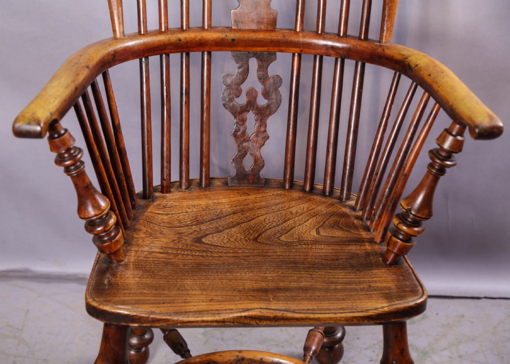 A 19th-century yew wood Windsor armchair featuring a bow back, ornate pierced splat, turned spindles, shaped seat, and turned legs. View VII