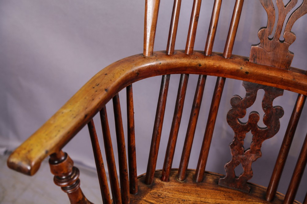 A 19th-century yew wood Windsor armchair featuring a bow back, ornate pierced splat, turned spindles, shaped seat, and turned legs. View IX