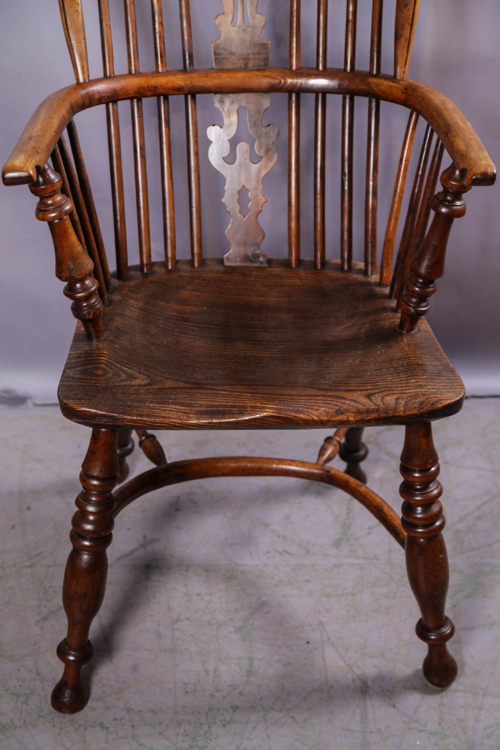 An antique yew wood high-back Windsor armchair featuring a pierced decorative splat, spindle back, shaped elm seat, turned legs, and a curved stretcher. View IV