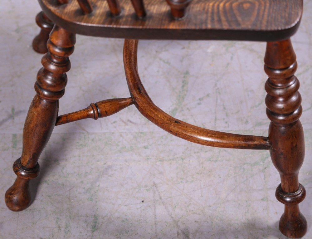 An antique yew wood high-back Windsor armchair featuring a pierced decorative splat, spindle back, shaped elm seat, turned legs, and a curved stretcher. View XI
