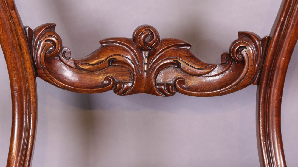 Set of four Victorian mahogany balloon back dining chairs featuring carved horizontal mid-rails, turned front legs, and brown velvet upholstered seats. View VII
