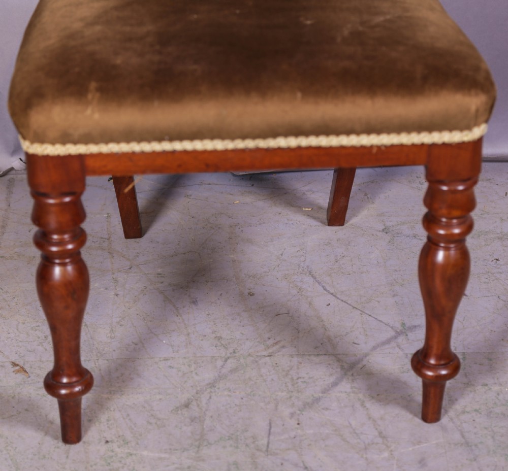 Set of four Victorian mahogany balloon back dining chairs featuring carved horizontal mid-rails, turned front legs, and brown velvet upholstered seats. View IX