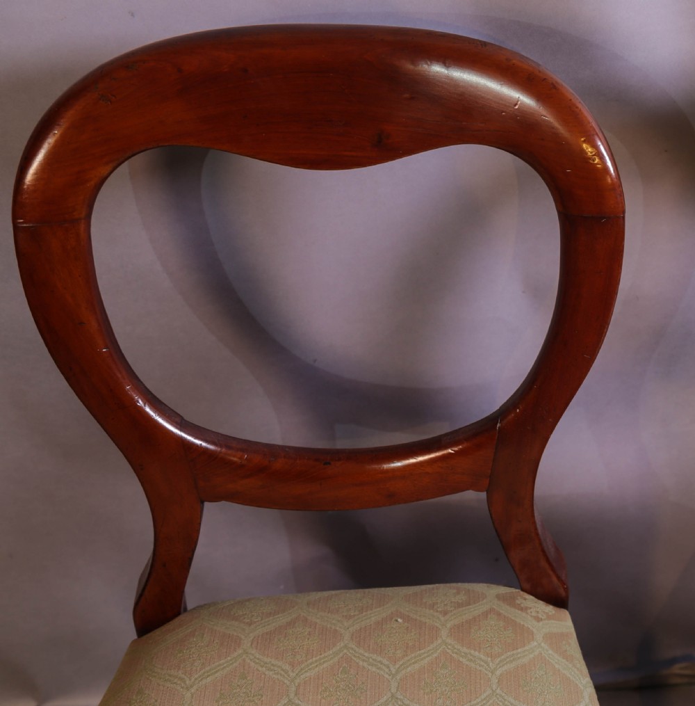 Set of eight Victorian mahogany dining chairs featuring rounded balloon backs, turned front legs, and patterned light-coloured upholstered seats. View VII