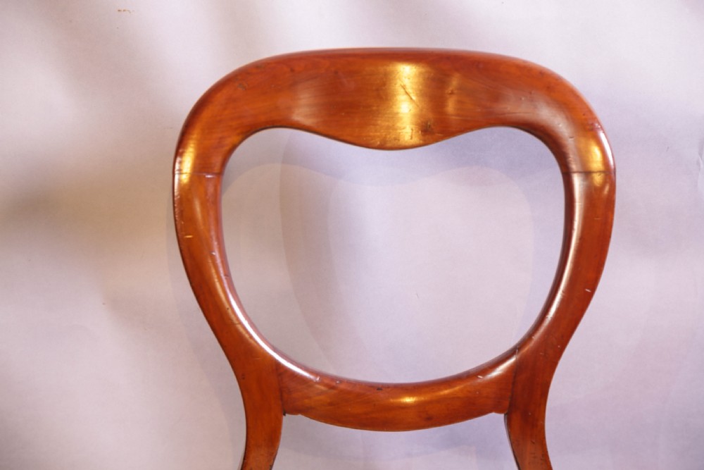 Set of eight Victorian mahogany dining chairs featuring rounded balloon backs, turned front legs, and patterned light-coloured upholstered seats. View XI