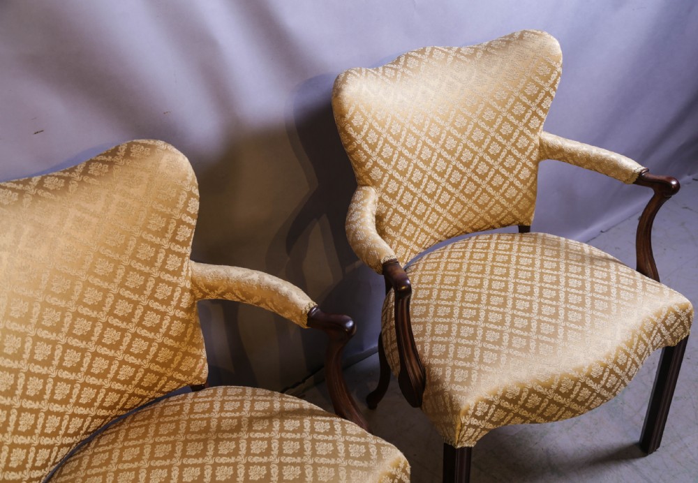 A pair of Georgian period mahogany armchairs upholstered in gold pattern damask fabric with swept timber arms. View V