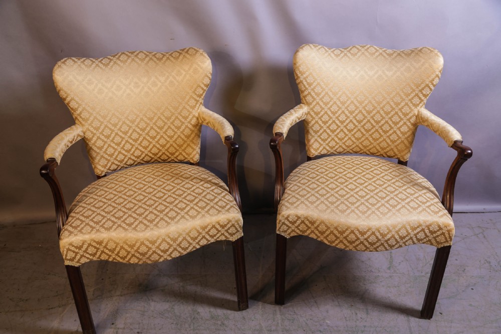 A pair of Georgian period mahogany armchairs upholstered in gold pattern damask fabric with swept timber arms. View VI